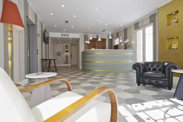Moderní hotelová recepce s pohodlnými křesly a designovým osvětlením.
