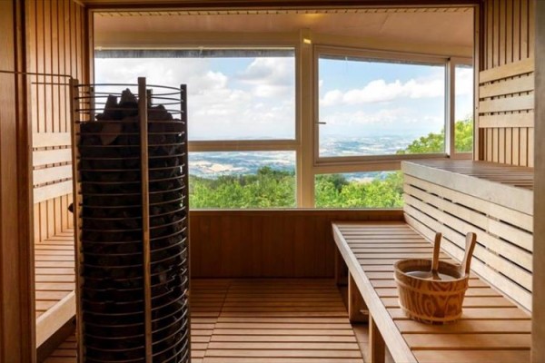 Sauna s výhledem na krajinu skrze velké okno.