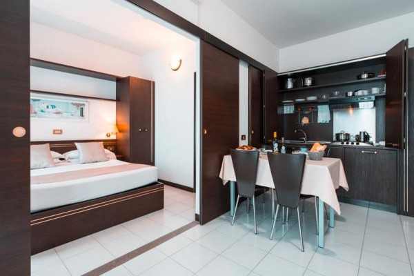 Moderní apartmán s ložnicí a kuchyňským koutem.